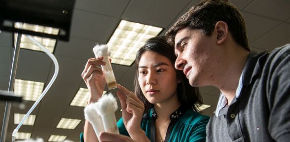 Two female undergraduate STEM students and professor at University of St. Thomas in Houston, Texas