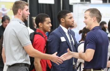 Students shake hands at University of St. Thomas - Houston job fair