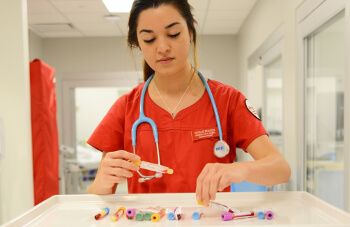 Female student at the University of St. Thomas - Houston works at pre-med internship