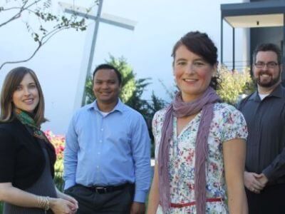 Graduate students with Chapel of St. Basil in the background at University of St. Thomas in Houston, Texas