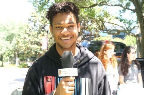 Student holding microphone on campus of University of St. Thomas in Houston, Texas (part 2)