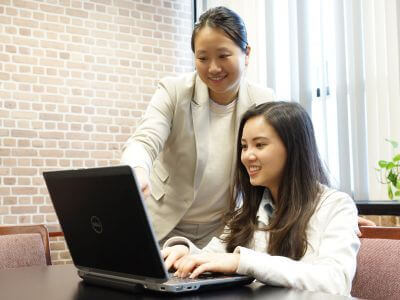 University of St. Thomas - Houston MSA Master of Science in Accounting student works at laptop with professor