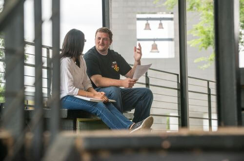 Psychology majors have a discussion in front of Chapel of St. Basil on University of St. Thomas - Houston campus