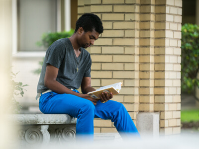 University of St. Thomas - Houston Mathematics student reads a book on campus