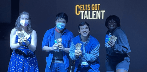 Student holding guitar on stage at Jones Hall during Celts Got Talent competition at University of St. Thomas in Houston, Texas