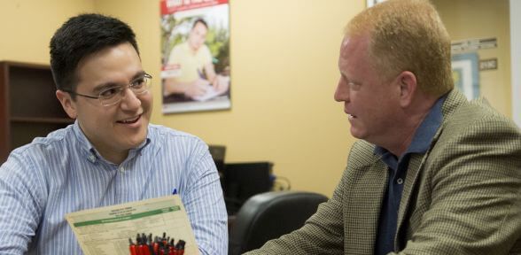 Student sitting at table with academic advisor at the University of St. Thomas in Houston, Texas