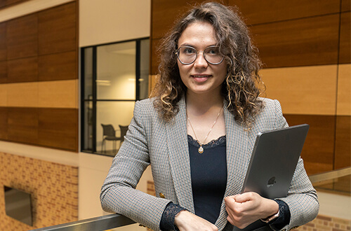 MS in Applied Data Science student works on laptop in University of St. Thomas - Houston library