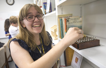 Student with mini chess board in University of St. Thomas - Houston Honors Program House